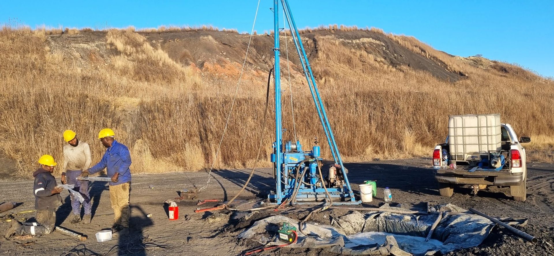 Geo Equilibria geologists inspecting drill core on site